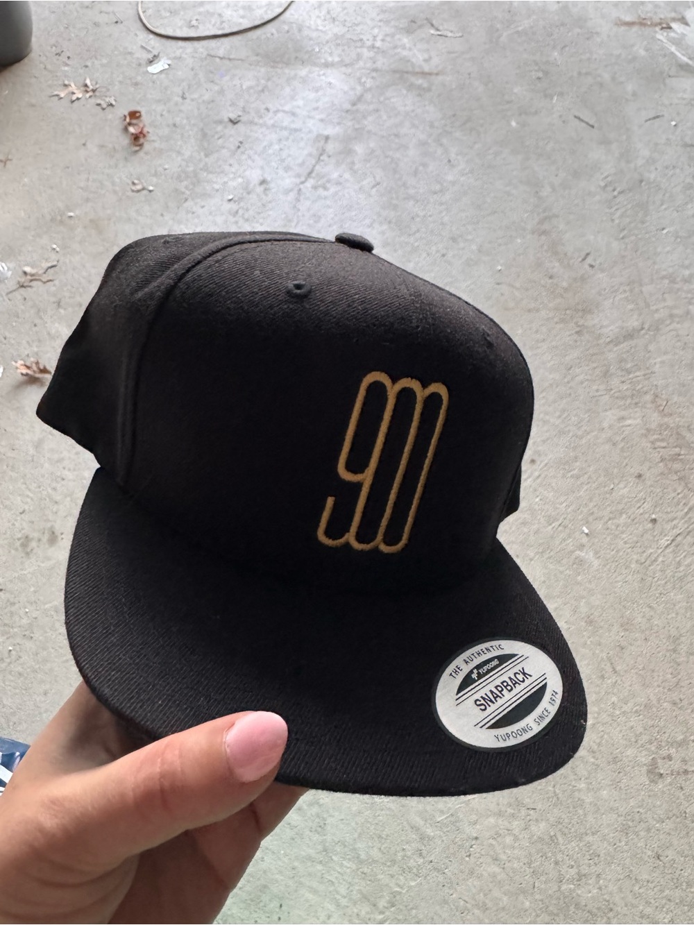 Black Snapback Hat with Gold Embroidered Logo